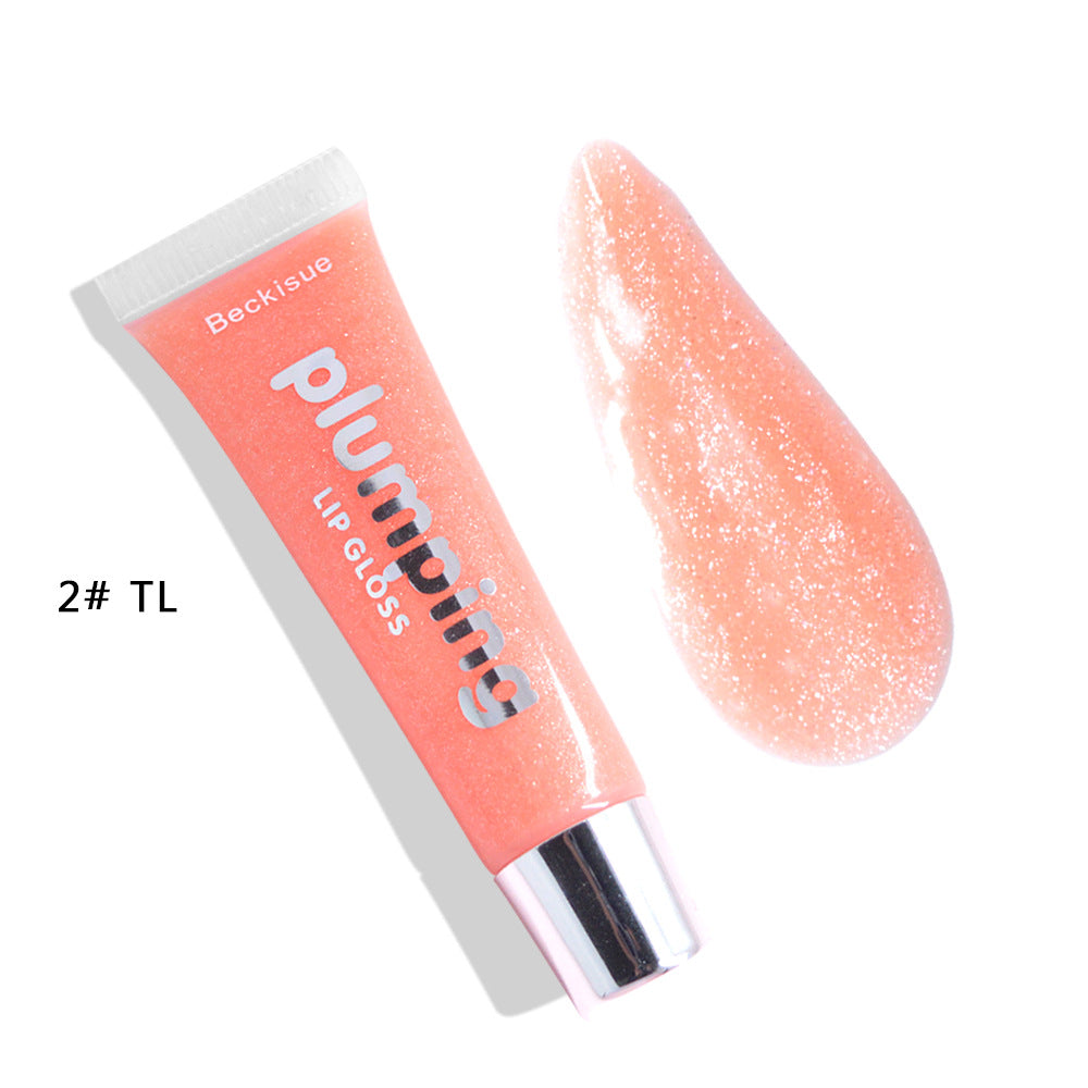 Brillo de labios húmedo con efecto volumen de cereza.