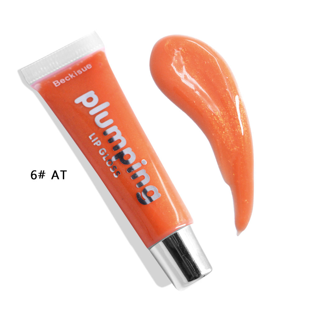 Brillo de labios húmedo con efecto volumen de cereza.
